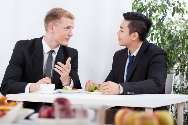 Diverse workers eating lunch in the office