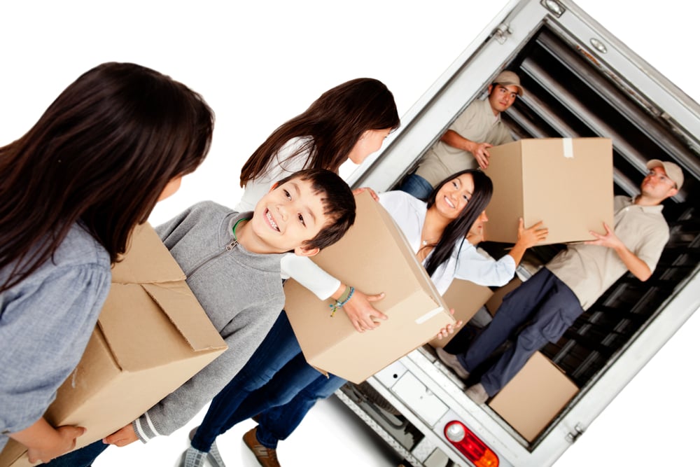Family moving house and loading a lorry - isolated over a white background