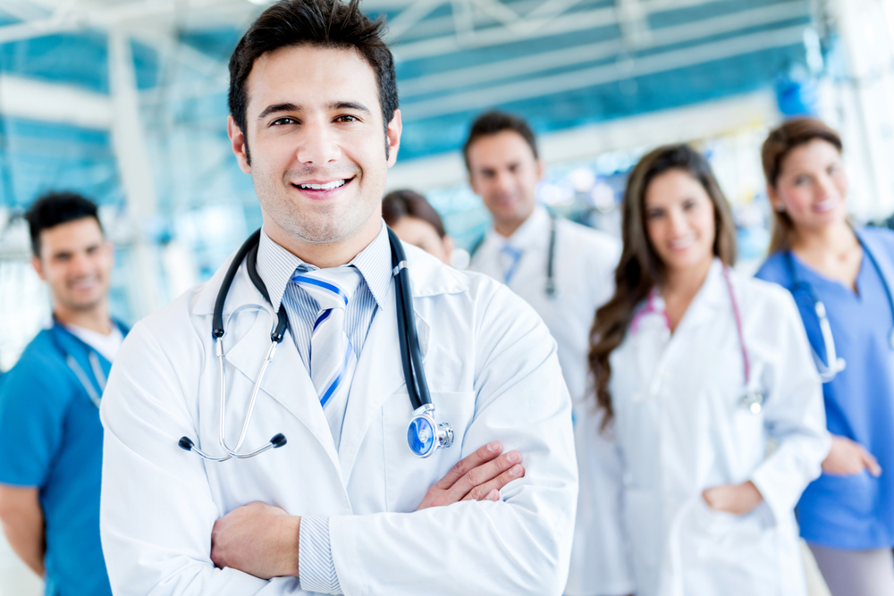 Man leading a group of doctors at the hospital