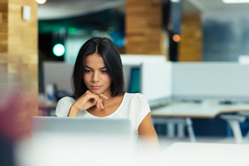 intern using laptop in office