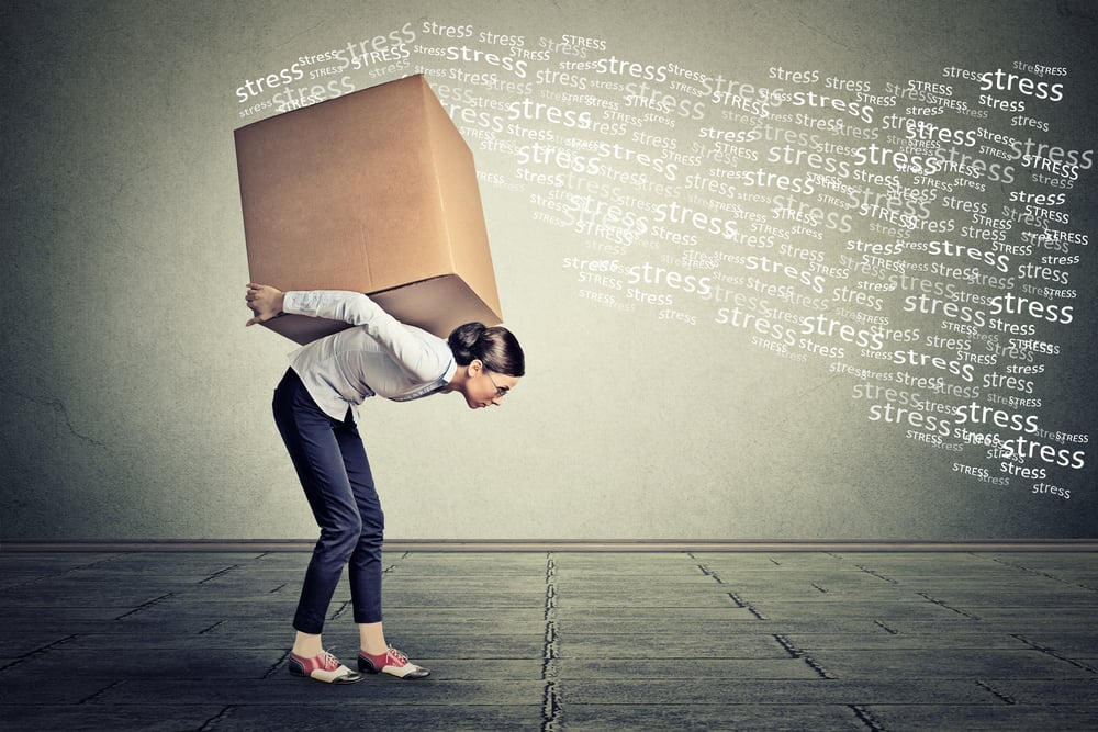 Stressed woman carrying on her back shoulders large box-1